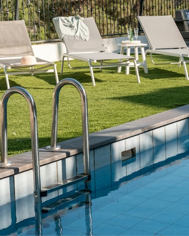 Pool with lounge chairs on a sunny day