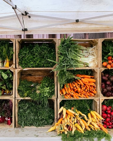 Colourful fresh vegetables displayed in wooden market crates